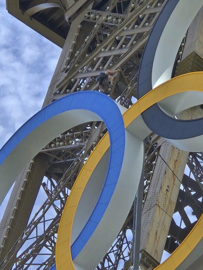 Homem escala Torre Eiffel antes da cerimônia das Olimpíadas